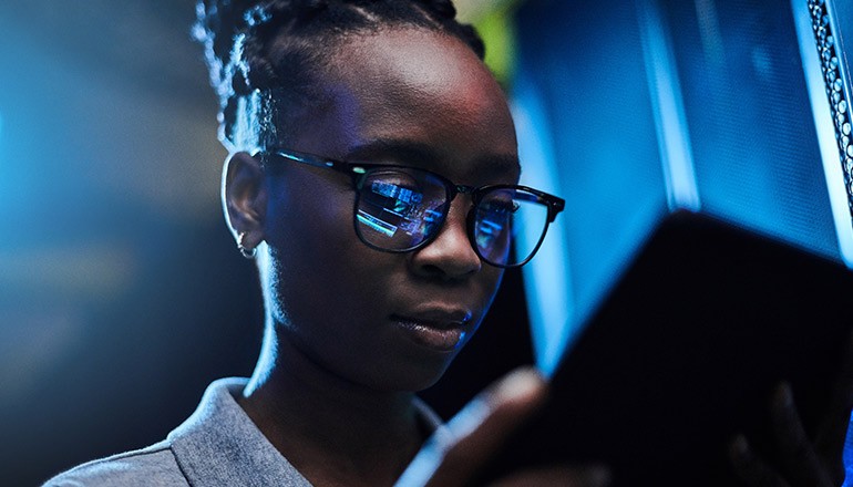 Mastering Visibility for Proactive Threat Detection Woman on tablet device