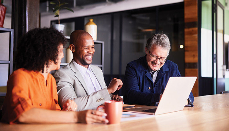 Cloud Migration in a Changing Economy: Strategies for Success With AVS Users smiling in office