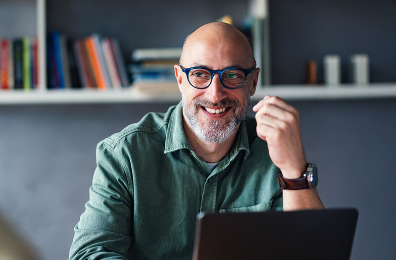 Business professional working off laptop remotely in modern office setting