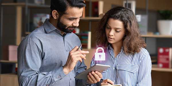 Two person looking at tablet device with an image of padlock