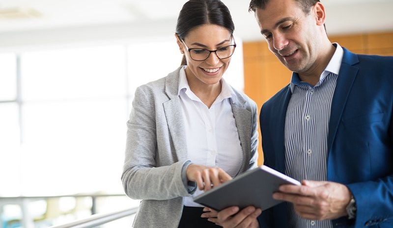 Move confidently to the cloud with Insight and Microsoft FastTrack. Two people working on a laptop