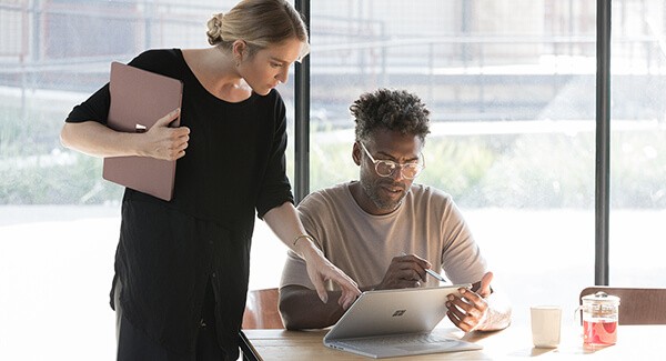 Employees meeting over a Surface tablet