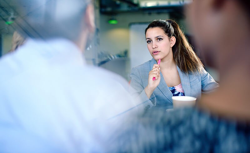 We'll ensure you have the knowledge and skills to be successful Female business woman asking question to training team