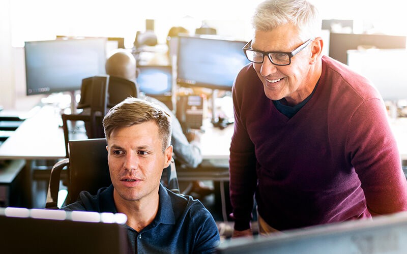 Our data scientists, business analysts, engineers and architects translate business requirements into technical requirements Business intelligence analyst reviewing data with manager