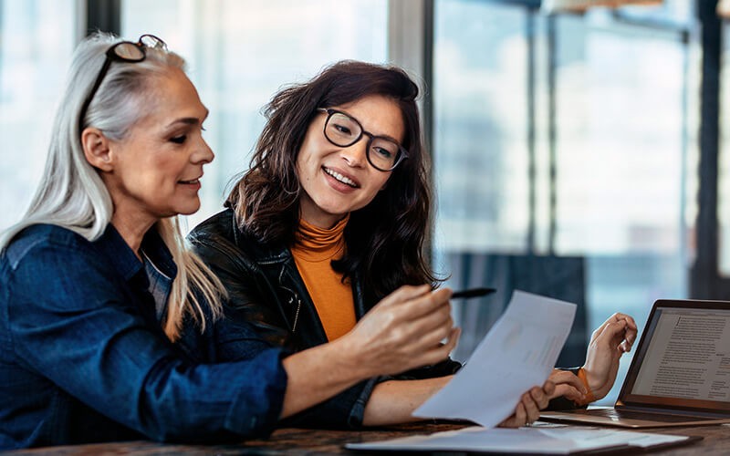 Manage project budgets, schedules and timelines. Project manager having discussion with designer