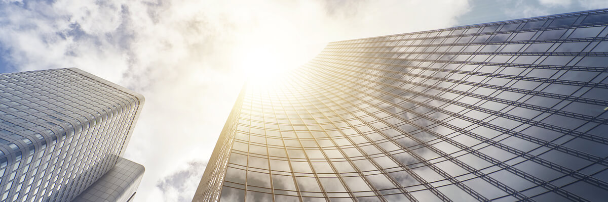 3 Federal Data Security Trends to Watch Modern glass high rise business building in clouds