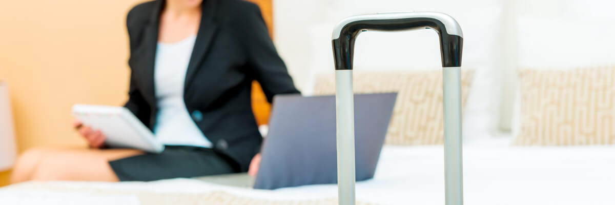 5 Hospitality Technology Trends Reshaping the Industry Business woman working on laptop in hotel room