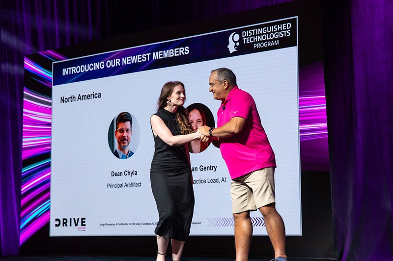 Our Distinguished Technologists keep Insight ahead in technology and delivering innovative solutions. Meagan Gentry shakes hand with Juan Orlandini and Phil Hawkshaw at Insight Mastery event 2024
