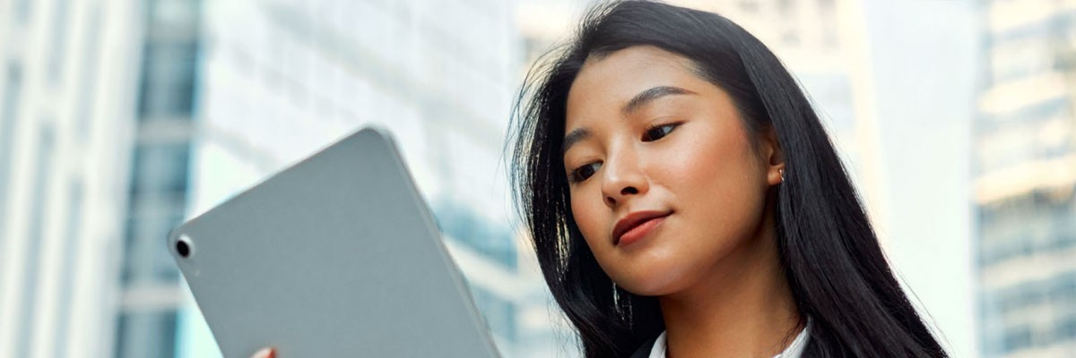 Let’s look at how to mitigate the most common device vulnerabilities Businesswoman with tablet outside in city