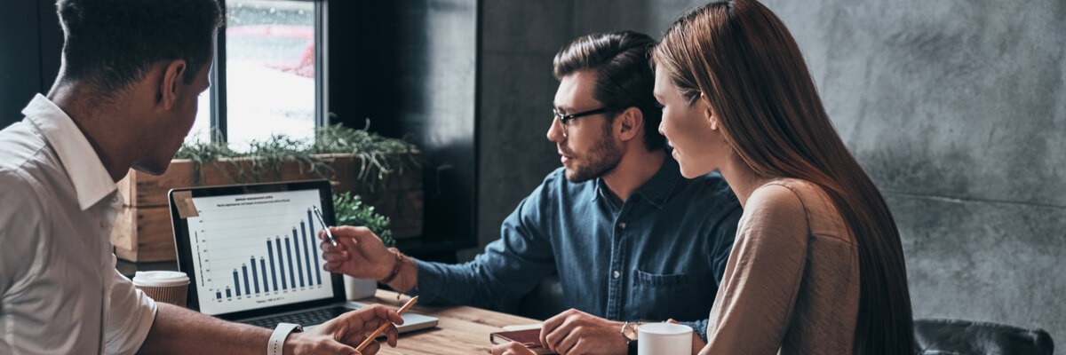 Bathroom Communications and the Rise of the OKR Platform Teammates collaborating around laptop