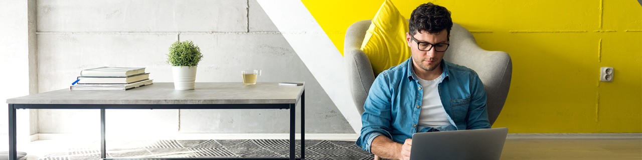 74% of employees agree that the ability to work remotely would make them less likely to leave their job Business professional sitting on floor in modern living room and working on laptop computer. Remote mobile work