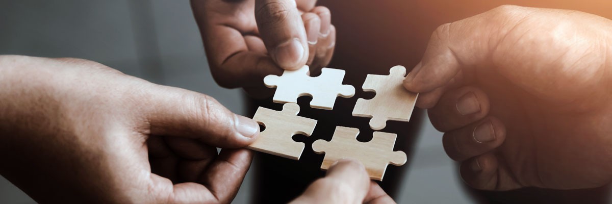 A company’s culture is fundamental to its success Various teammates holding puzzle pieces that fit together to form a bigger piece