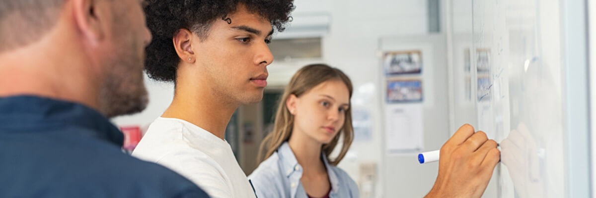 How can we use automation to streamline processes and reduce costs? Laptop and pile of business charts