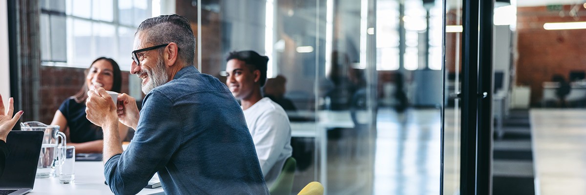 Positioning Your Teams for Successful SAP S/4HANA Migration Team smiling in office