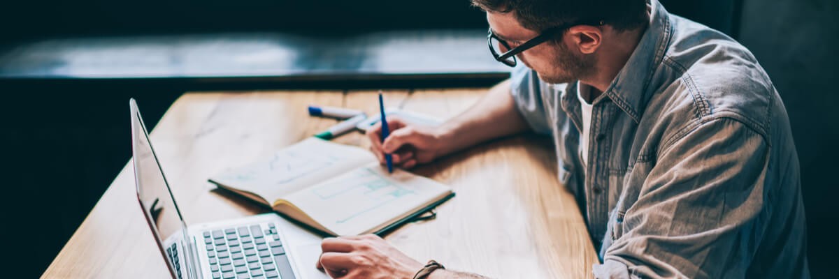 Reduce Your IT Spend With FinOps for Cloud Man working on laptop