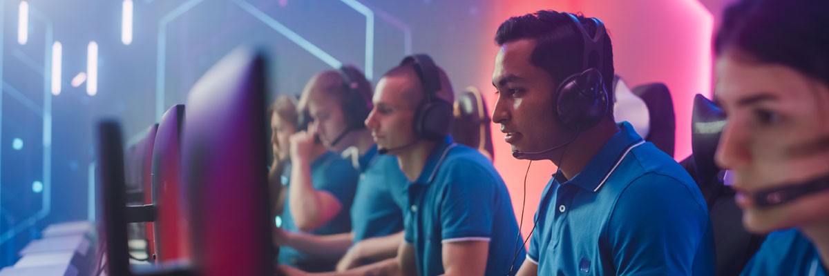 Learn about the advantages and practical applications of establishing an Esports program Students on gaming computers in esports program