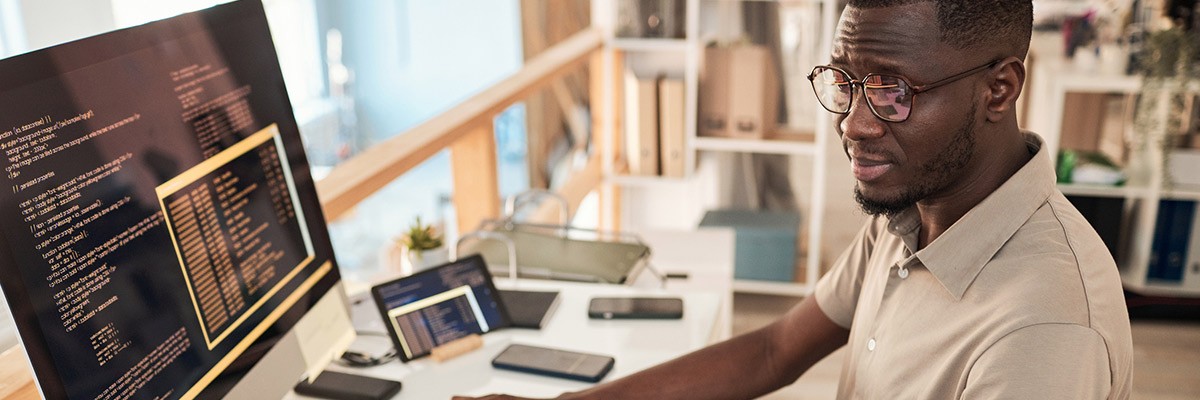 The Unified Value of Agile and DevOps Developer working on monitor at desk