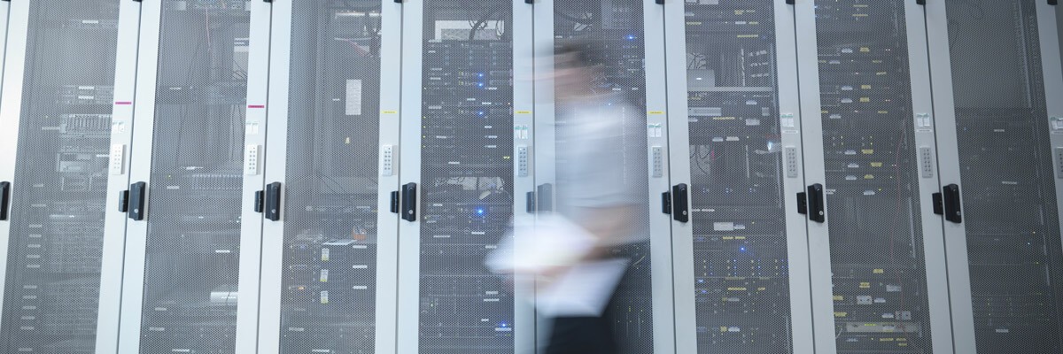 APC is a leading sustainability resource for data center products and solutions. Engineers walking past sustainable and modern data storage systems