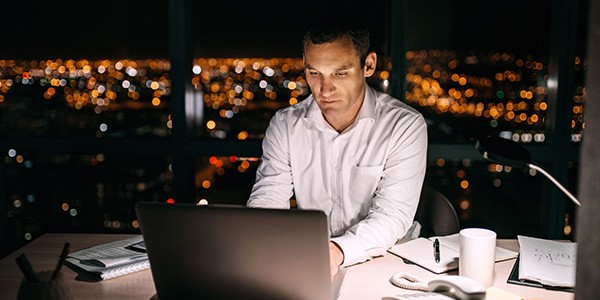 Making a Modern Workplace with Mac business man working on laptop at night