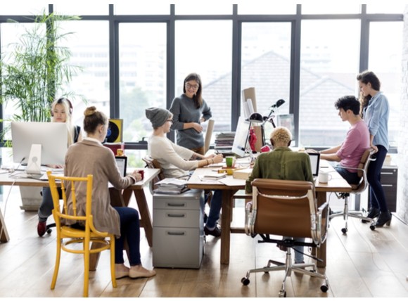 Find out why organizations are turning to cloud-delivered security services Teammates in work space using computers.