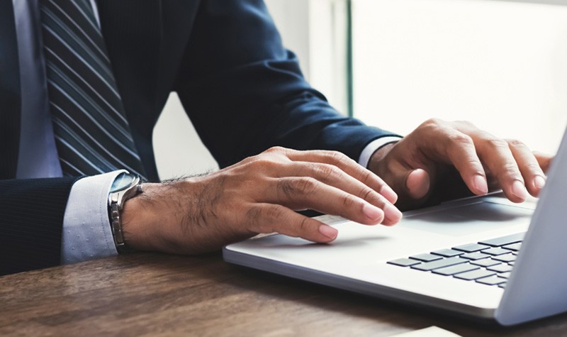 Government agencies learn why security on every device is imperative Business man using laptop