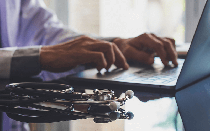 Learn more about the connected healthcare journey Doctor on laptop computer with stethoscope nearby