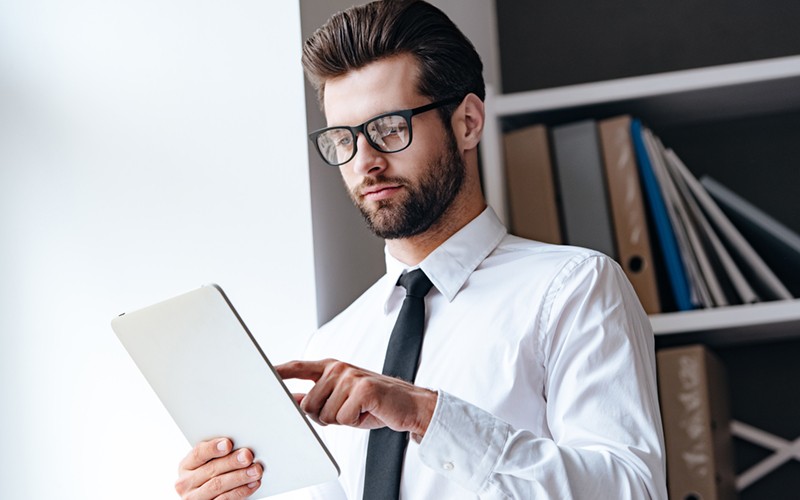 Learn steps you can take to secure your cloud app environment Professional businessman reading report off of tablet device utilizing the cloud