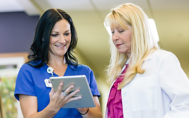 Hybrid healthcare teams need powerful, reliable tools Two healthcare professionals working together