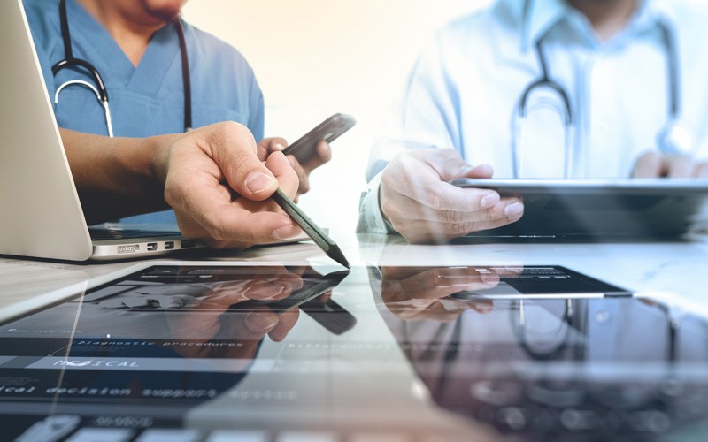 Discover how healthcare organizations can leverage innovation Two doctors discuss patient results over tablets