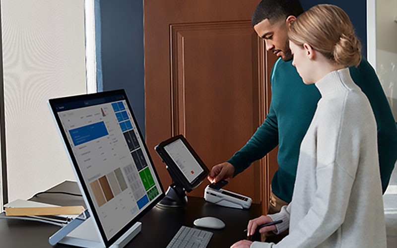 Achieve more flexible retail work with Microsoft Surface devices Woman in retail store using Microsoft Surface