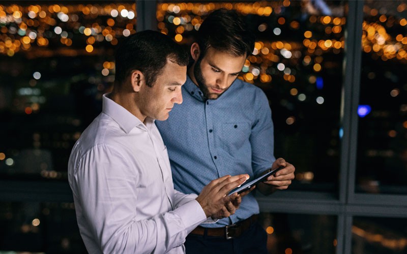 How cloud storage improves collaboration Two coworkers looking at a tablet