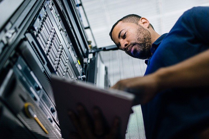 Transform your datacenter with cloud technology IT professional in data center on tablet device