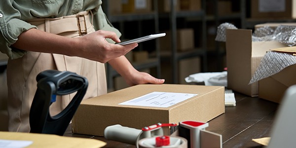 Transform employee satisfaction and enhance the customer experience Business owner using mobile device to ease retail workload