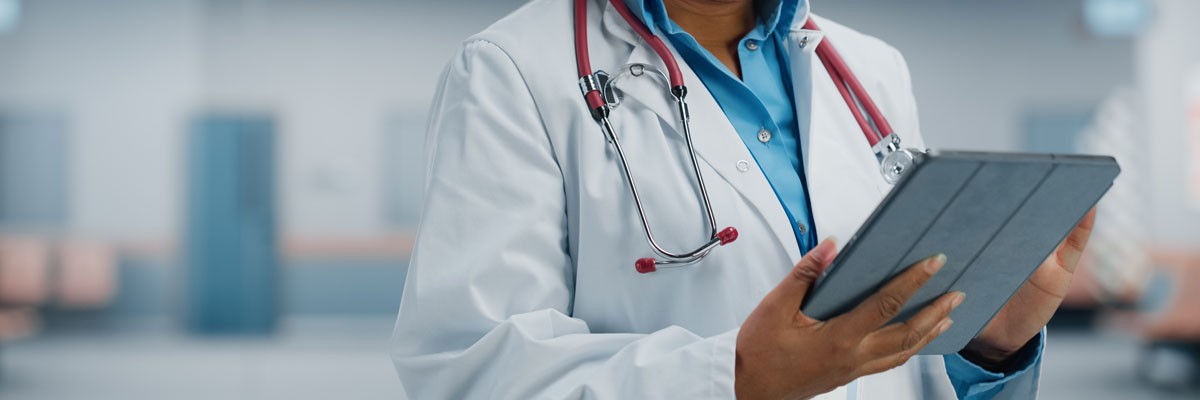 A Leading Healthcare Provider Transforms Their Data Center Ecosystem Doctor with tablet device