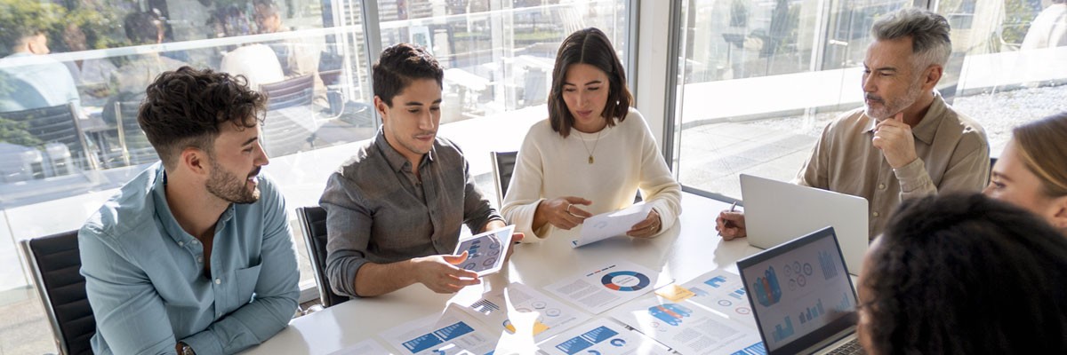 Aligning Security Solutions and Business Objectives Group of business professionals gathered around in meeting