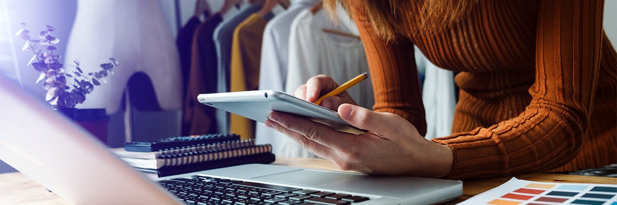 Easily create and work with visual concepts Retail merchandiser reviewing design concepts off Apple devices as they are working on store displays and visual concepts.