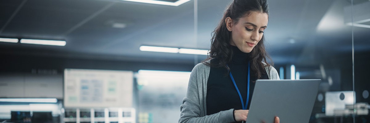 Cable ONE Aces Data Center Move with Insight Business professional on laptop in data center