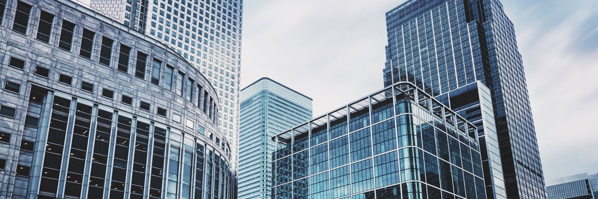 Healthcare Company Scales and Modernizes IT to Address Rapid Growth Demands Doctor holding tablet device with patient data while sitting at desk with laptop computer