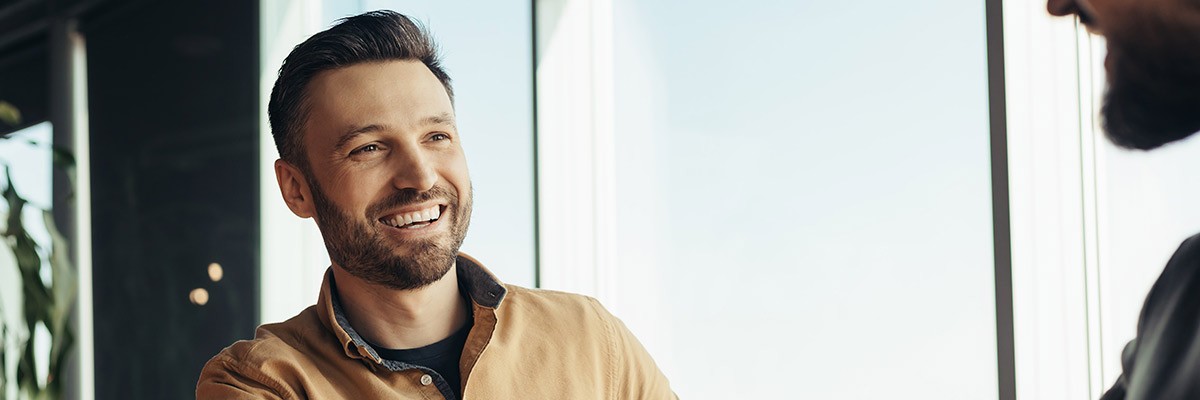 Serving up a better candidate experience to attract and onboard talent Smiling business candidate