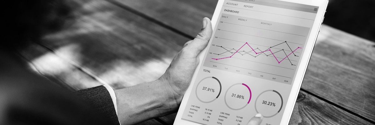 Financial Analytics Firm Boosts Agility With Data Migration User looking at analytics displayed on tablet