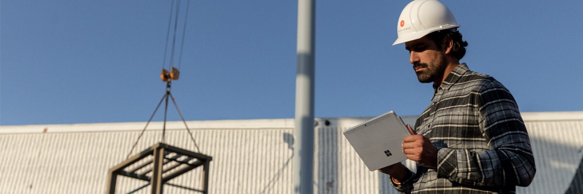 Financial Management for Azure Cloud case study Man working on Microsoft Surface product in field cover