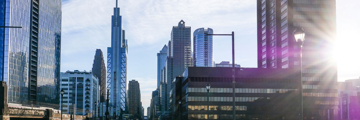 Financial Services Giant Enables Innovation and Scale in Azure View of sunrise rising over skyscrapers in the city