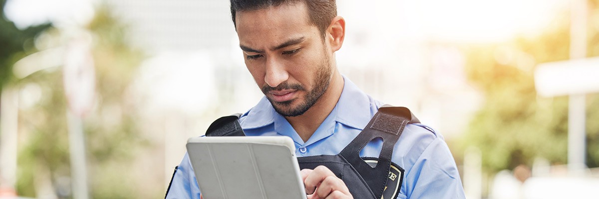 Tech Company Maximizes Revenue Potential State and local officer using tablet device on field