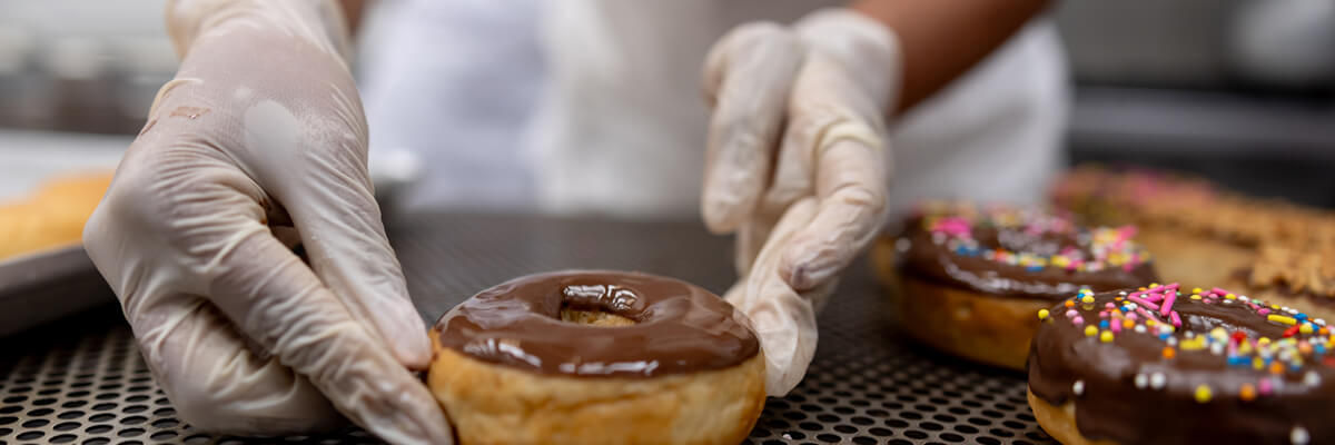 Global Doughnut Chain Transforms Across Applications, Data and Cloud Chef in kitchen working on donuts