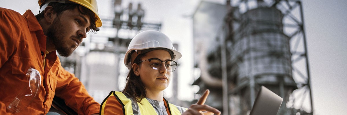 Global Motion and Control Technology Corporation Gets Compliant and Fully Managed Microsoft Exchange Environment Two engineers at construction site looking at plans with laptop computer