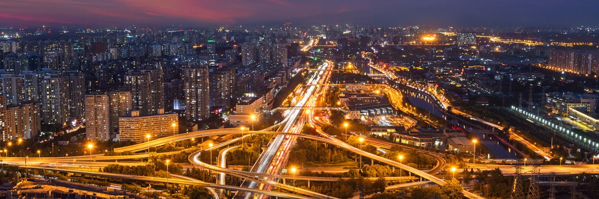 International Manufacturer Turns to Insight for Critical Network, Voice, and Telecom Solutions Bird's eye view of city and highways at night
