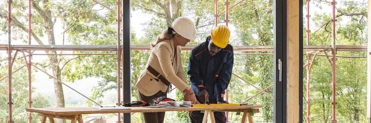 Luxury Home Builder Redefines its Blueprint for Success with Colocation, Automation, and Virtualization Architect and building planner go over plans for construction of new residential home