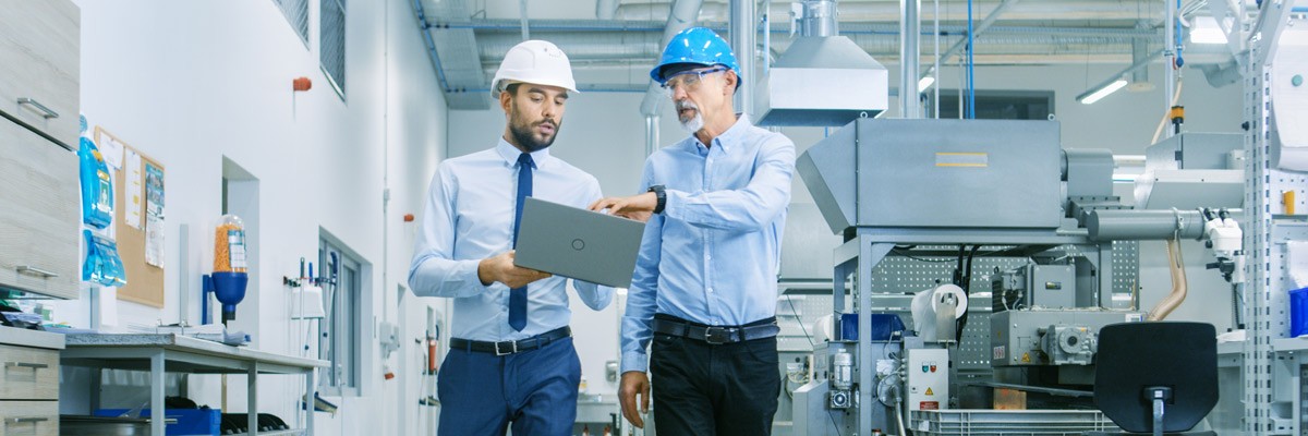 Multinational Conglomerate Enhances Security and Compliance Two men walking through manufacturer warehouse