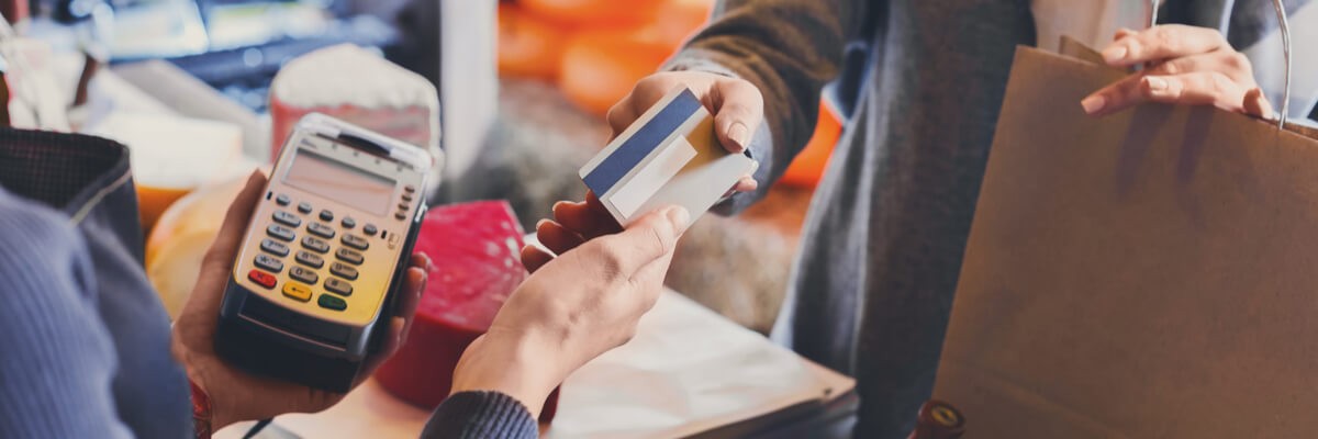 National Retailer Conquers Wide-Scale Deployment Merchant being handed a credit card