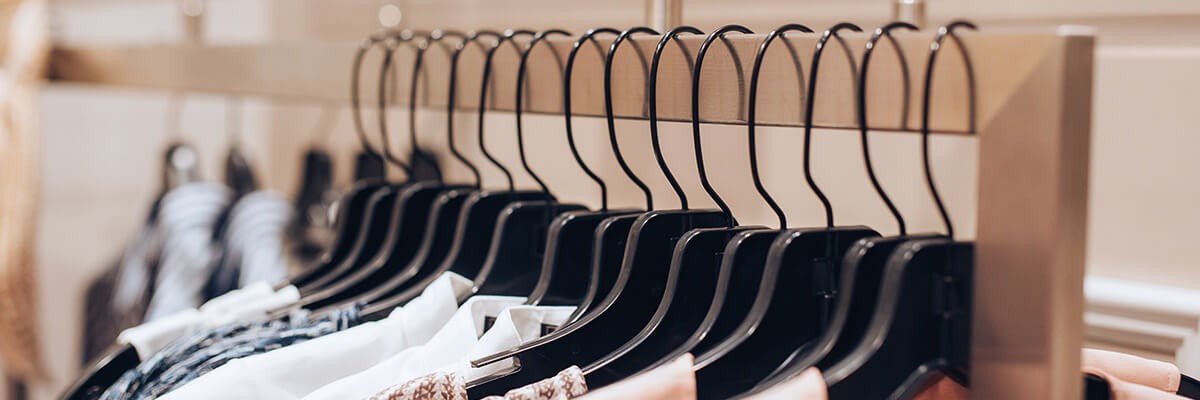Retailer Triples Identity Secure Score With Improved Cloud Ops and Modern IT Strategy Clothes on hanger in retail store
